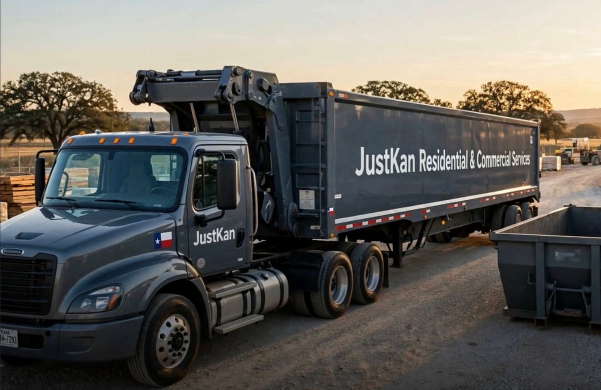 JustKan Residential & Commercial Services garbage truck parked at a waste disposal facility at sunset